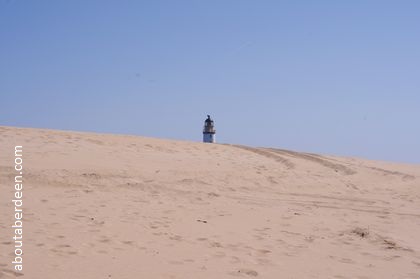 Lighthouse over sand dunes