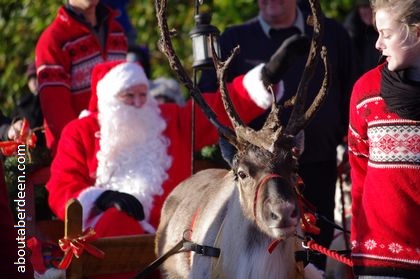 Santa being pulled by reindeer on sleigh