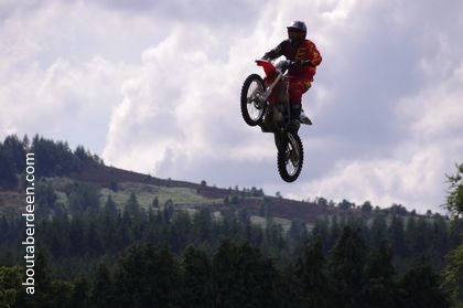 motorcyclist jumping between two ramps