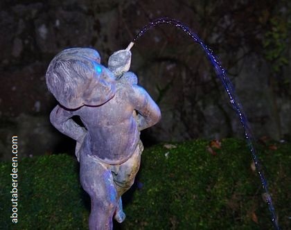 statue fountain lit up water